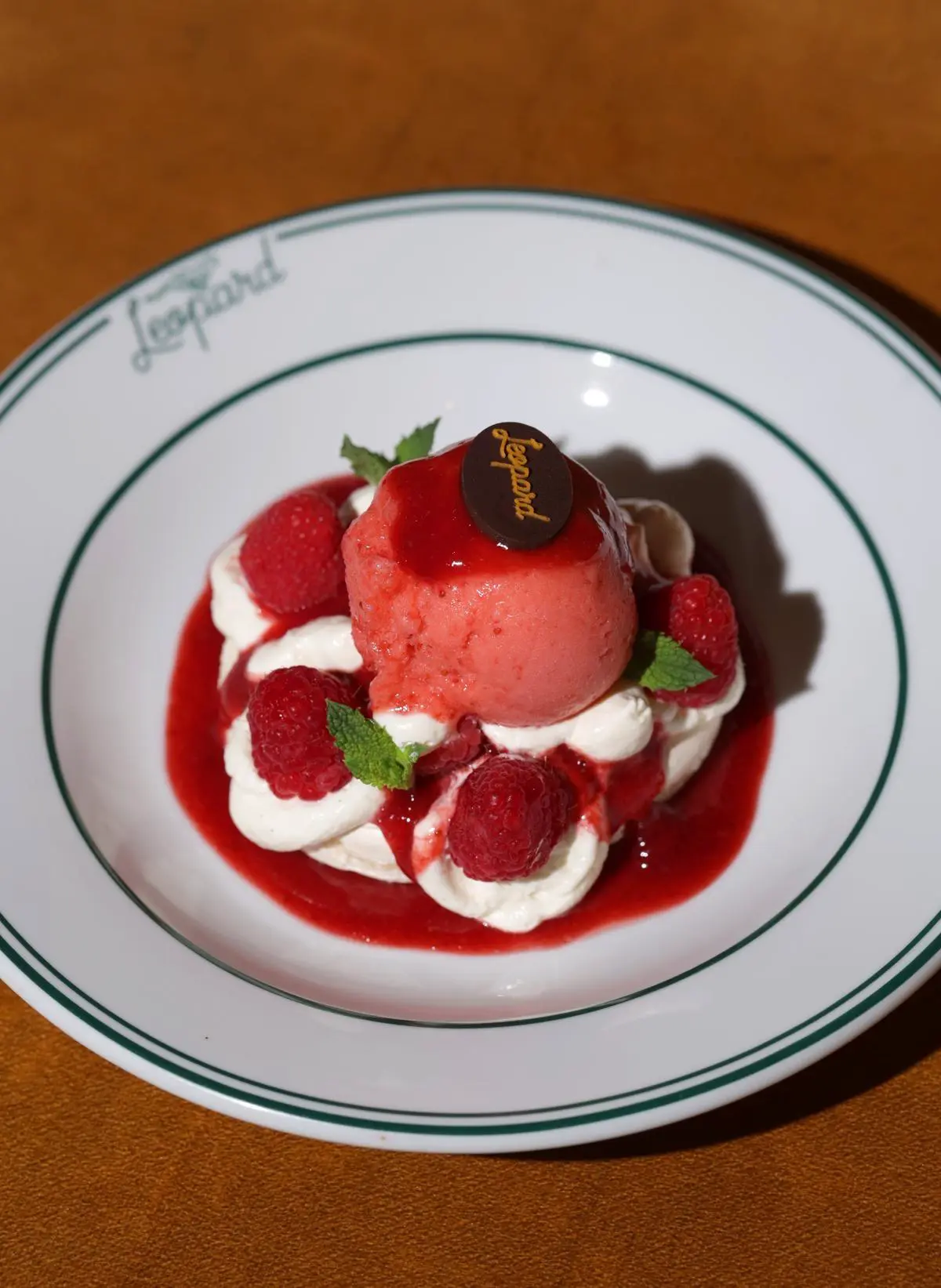 Pavlova with red fruits, whipped cream & raspberry ice cream